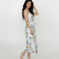 Ankle-length chinon dress with abstract floral print, featuring a flowy silhouette and halter neckline with tie-back detail