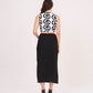 Sleeveless crop top back featuring an exposed metal zipper closure paired with a clean, straight-cut midi skirt.