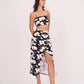 Black floral co-ord set, emphasizing the slit of the printed wrap skirt.
