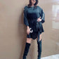 Belted black mini dress with shell embroidery and lace accents, perfect for parties and elegant nights out