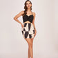 Straight-cut mini silhouette featuring a thigh-high hemline and a bold monochrome block pattern. The Abstract Allure design provides a chic, leg-lengthening look.