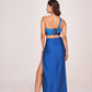 Back view of a blue satin co-ord set with a one-shoulder top and skirt featuring a back zip closure