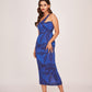 Form-fitting midi silhouette showcasing the complete botanical print layout against the vibrant royal blue backdrop. 