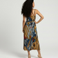 Contemporary midi dress with clean square neckline, soft drape, and artistic geometric print for effortless resort elegance
