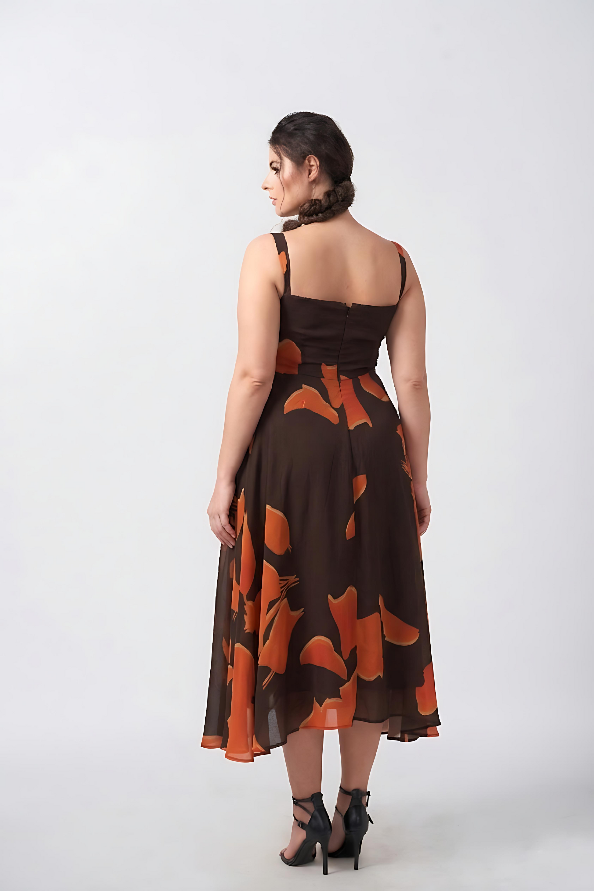 Crepe midi dress with orange abstract print and fluid silhouette, perfect for brunches, daytime gatherings, and evening wear