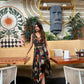 Halter-neck abstract print maxi dress with a front slit, suitable for resort getaways and vacation evenings