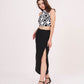 High-waisted black skirt design highlighting a prominent side slit for ease of movement and a sleek, fitted profile.