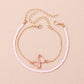 This handcrafted pink butterfly anklet combines earthy beads with a whimsical charm, making it an ideal accessory to brighten up your vacation wardrobe