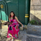 Vibrant oversized floral print dress with graceful movement and modern scarf detail