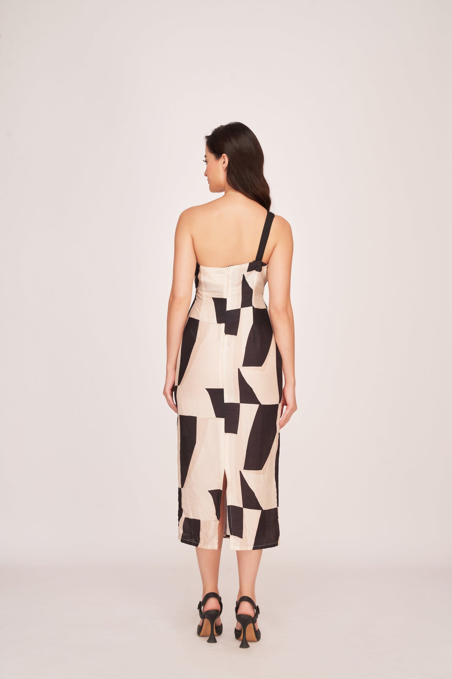 Back view of a one-strap silk midi dress with a back zip closure and clean lines