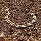 This eye-catching golden shell link anklet captures a bohemian spirit, making it a great choice for festival outfits, beach parties, or a unique date night look.