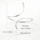 A minimalist silver open-cuff anklet featuring a smooth, sculpted metal finish with rounded ends, perfect for adding a modern, high-fashion edge to a gallery opening or an upscale dinner.