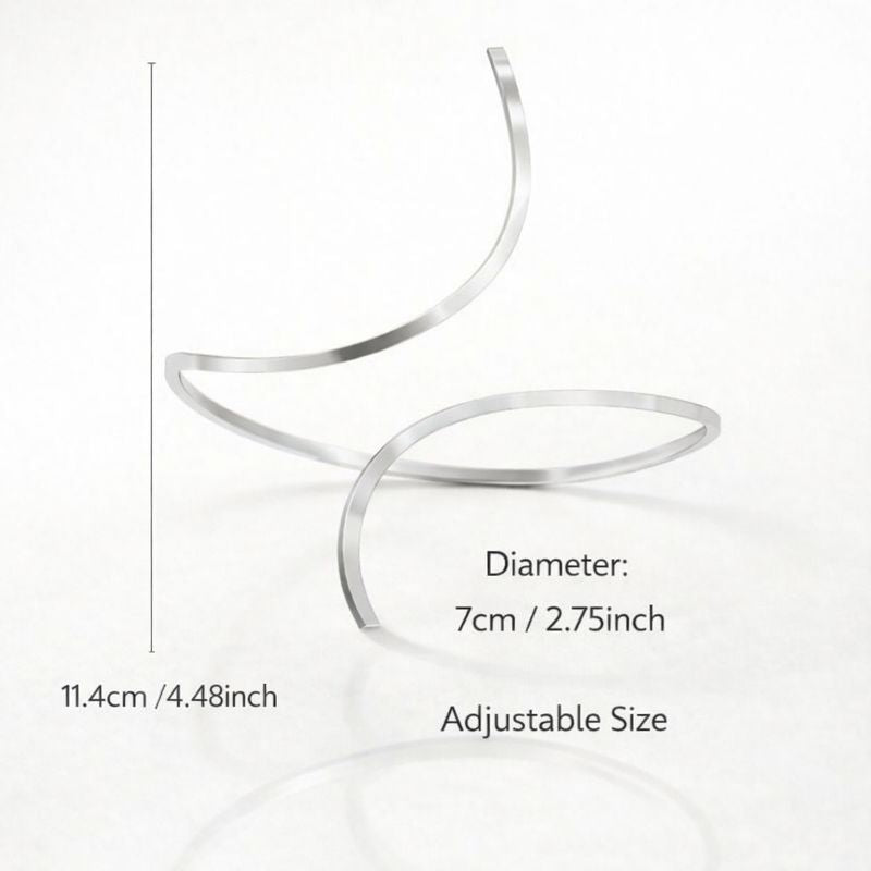 A minimalist silver open-cuff anklet featuring a smooth, sculpted metal finish with rounded ends, perfect for adding a modern, high-fashion edge to a gallery opening or an upscale dinner.