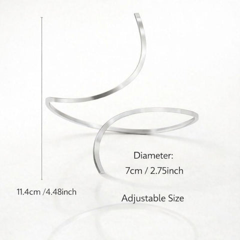 A minimalist silver open-cuff anklet featuring a smooth, sculpted metal finish with rounded ends, perfect for adding a modern, high-fashion edge to a gallery opening or an upscale dinner.