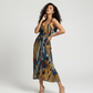 Elegant midi dress in airy chinon with slim straps, bold abstract print, and front slit, perfect for vacation evenings