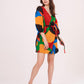 Multicolor wrap dress featuring a bold geometric print in vibrant shades of red, green, orange, and blue.