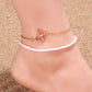 A slim and lightweight pink beaded anklet with a dainty butterfly accent, designed to be a charming companion for casual weekend outings or a tropical getaway.