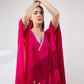 Pink kaftan dress with shell embroidery, lace detailing, and relaxed v-neckline.