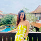 Yellow printed tube dress with an elasticated strapless neckline and sculpted fit