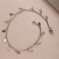 This high-shine silver charm anklet offers a clean and modern aesthetic, designed to be a versatile staple that elevates both your professional office attire and your favorite holiday outfits.