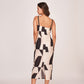 Back view of a silk midi dress with shoulder straps, side cut-outs, and a back zip closure