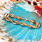 An elegant gold-toned shell anklet with a high-shine finish, an ideal accessory to add a touch of beachy glamour to your sunset dinner or vacation wardrobe.
