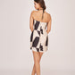 Back view of a silk mini dress with a clean finish and back zip closure