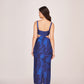Back view of a blue silk midi dress with shoulder straps and a back zip closure
