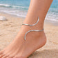This silver anklet offers a bold and contemporary silhouette, designed to effortlessly elevate your vacation wardrobe or add a refined edge to your favorite pair of heels.