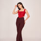 Full-length view showcasing the straight-leg cut of the burgundy pants and the curved hemline of the crop top, ideal for semi-formal occasions.