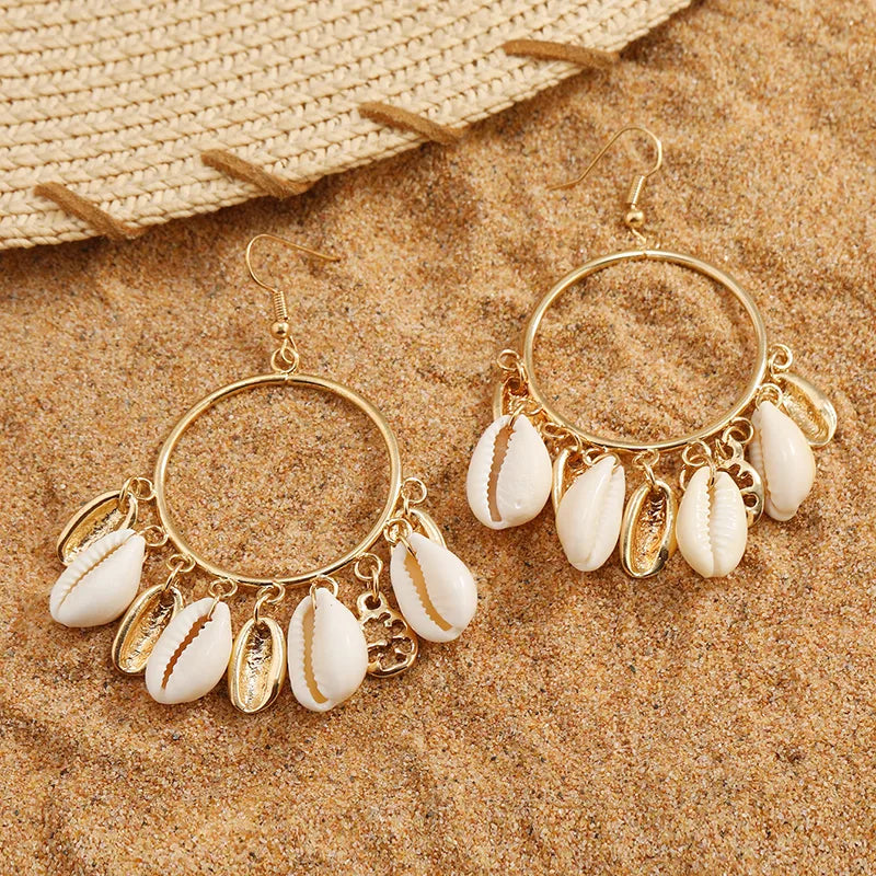 Imitation Gold Shell Drop Earrings featuring large circular hoops with multiple dangling white cowrie shells and gold charms