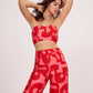 Red and pink tube top highlighting a subtle sweetheart neckline and a bold abstract geometric print.