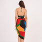 Rear view highlighting the tie-back detail of the crop top and the smooth drape of the sarong skirt. The Beach Sarong Wrap features a bold abstract pattern that stands out from every angle.