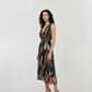 Sleeveless fit-and-flare dress featuring a deep V-neckline and a wrap-style bodice that creates a structured, flattering waist.