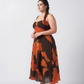 Flowy crepe midi dress in warm orange and brown abstract print, offering a flattering fit with effortless movement