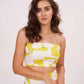 Close-up of the neckline and straps, highlighting the square-neck design, soft fabric texture, and confident expression.