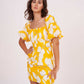 Yellow printed muslin dress with a flattering, structured summer silhouette