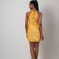 Rear view of the tulip-cut yellow dress showing open back halter neck design and flowy silhouette.
