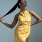 Yellow muslin dress with a halter neckline and sleeveless silhouette